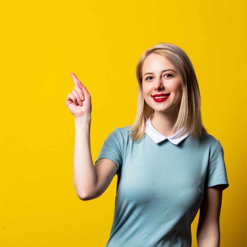 smiling-blonde-girl-in-blue-dress-on-yellow-backgr-2024-09-25-23-36-23-utc